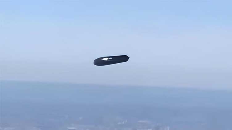 A baffling 'flying cylinder' captured on camera above New York.